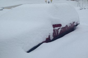 Car buried in snow again.